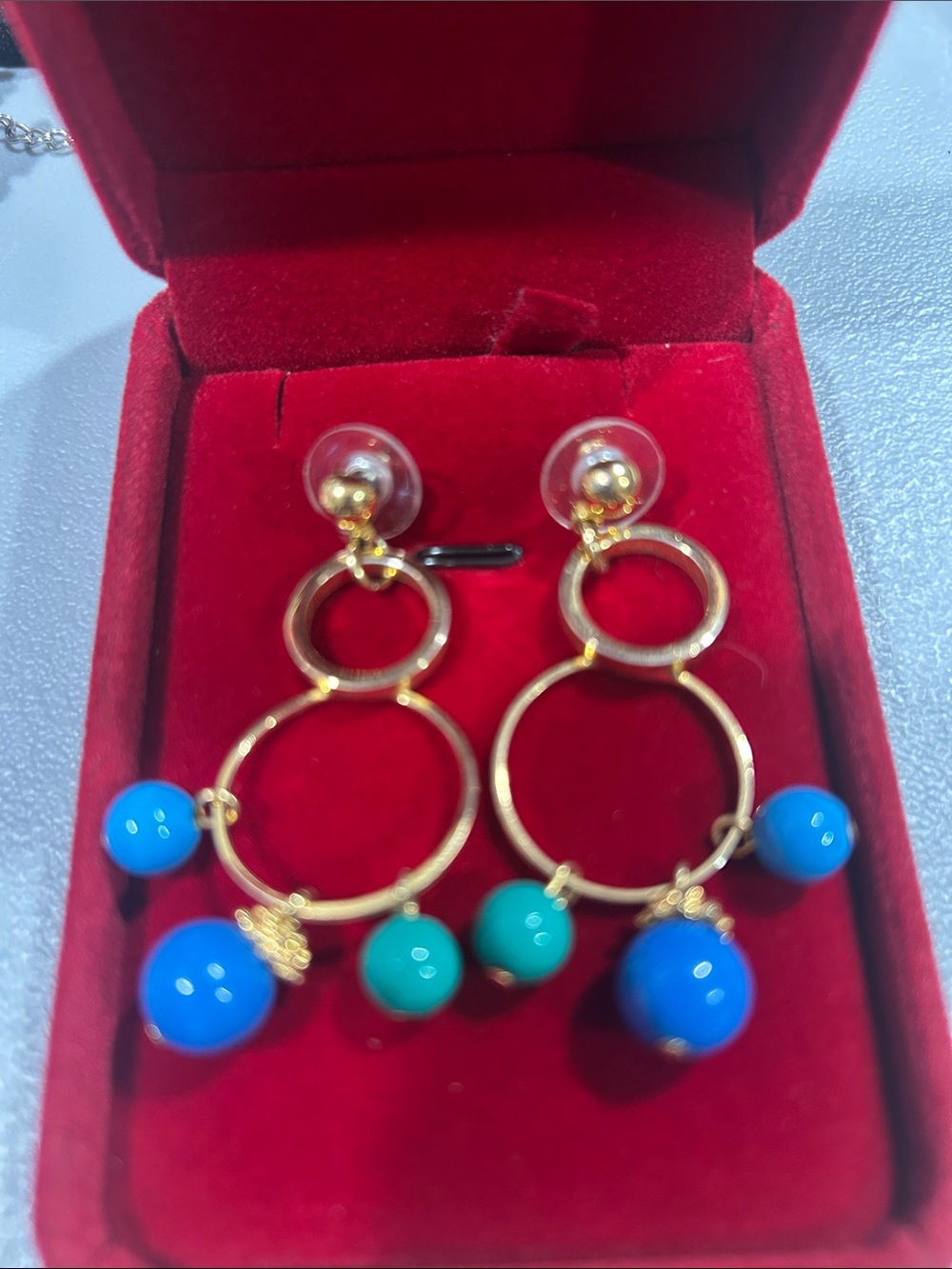 Gold tone double circle dangle earrings with blue and turquoise beads statement